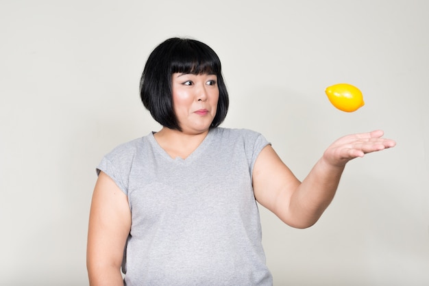 young beautiful Asian woman with short hair on white