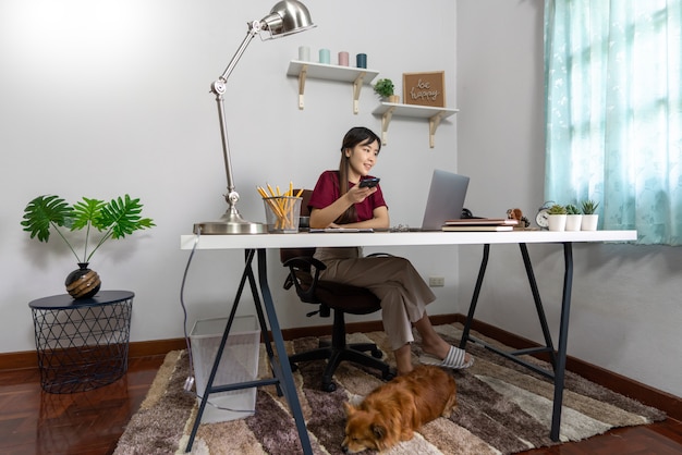 Young beautiful asian woman working at home