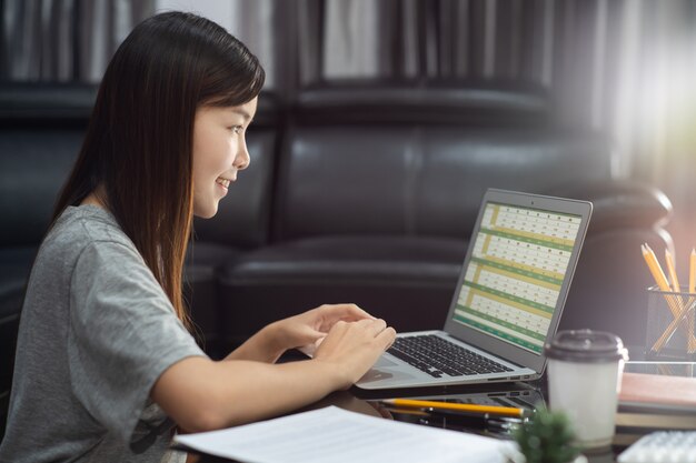 Young beautiful asian woman working at home