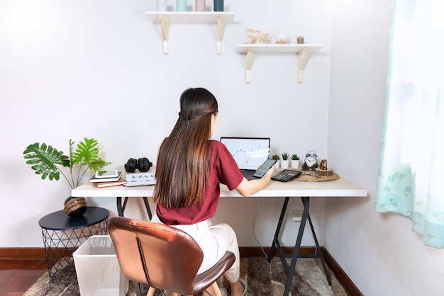 Young beautiful asian woman working at home