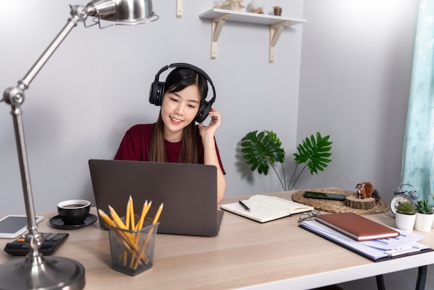 Young beautiful asian woman working at home