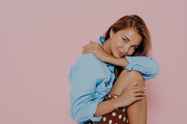 Young beautiful attractive woman sitting on chair with legs up