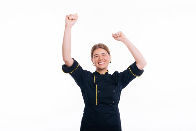 Photo young beautiful baker woman wearing uniform cooking over white background celebrating for success with arms raised
