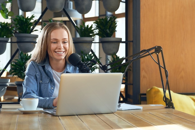 Young beautiful blogger woman conducting live broadcast