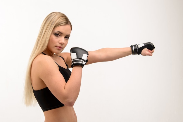 Young beautiful blonde sexy boxing girl posing with gloves