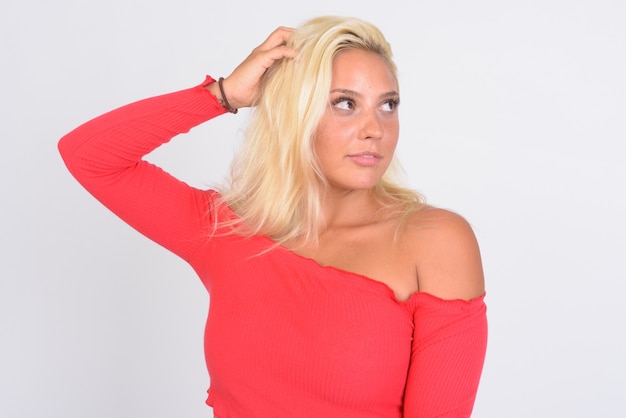  young beautiful blonde woman against white wall