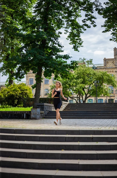 a young beautiful blonde woman runs up the stairs