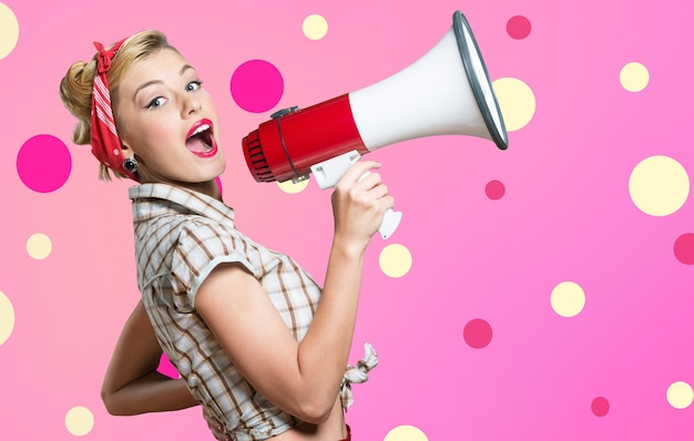 Young beautiful blonde woman with loudspeaker