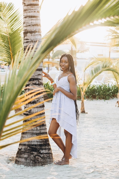 Young beautiful Brazilian girl staying on beach