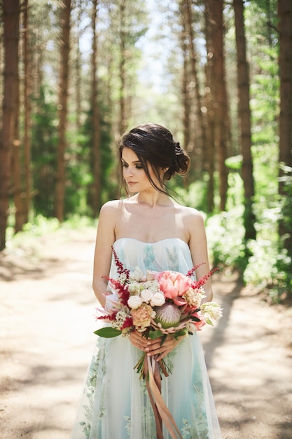 Young beautiful bride in a blue wedding dress