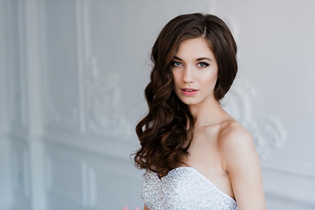 Young beautiful bride standing in antique interior