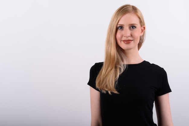 Young beautiful British woman with blond hair against white background