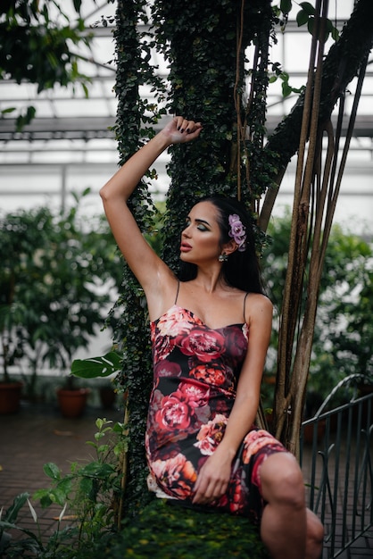 A young beautiful brunette posing among dense thickets of jungle and rainforest. Spa