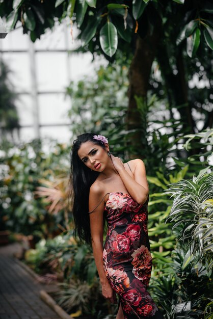 A young beautiful brunette posing among dense thickets of jungle and rainforest. Spa.