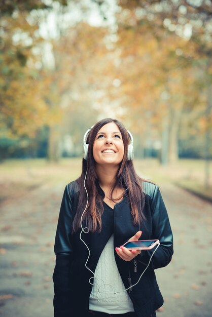 young beautiful brunette straight hair woman in the park 