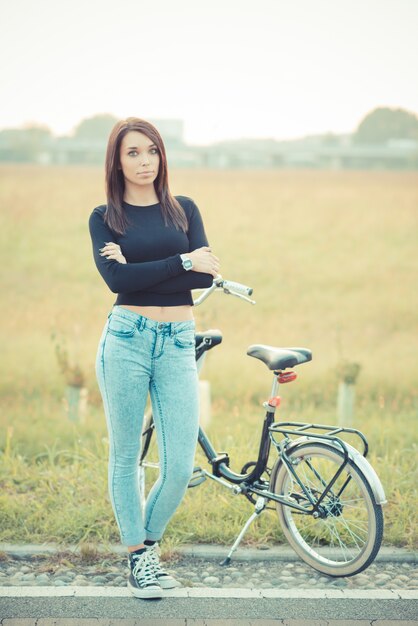 young beautiful brunette straight hair woman using bike