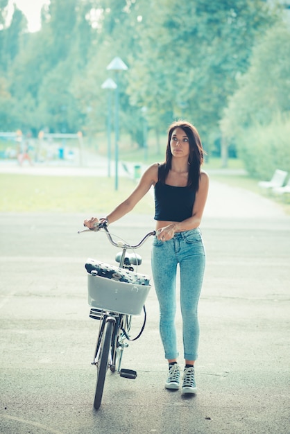 young beautiful brunette straight hair woman using bike