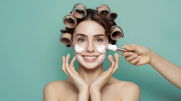 Young beautiful brunette woman in hair curlers smiling creaming face facial treatment