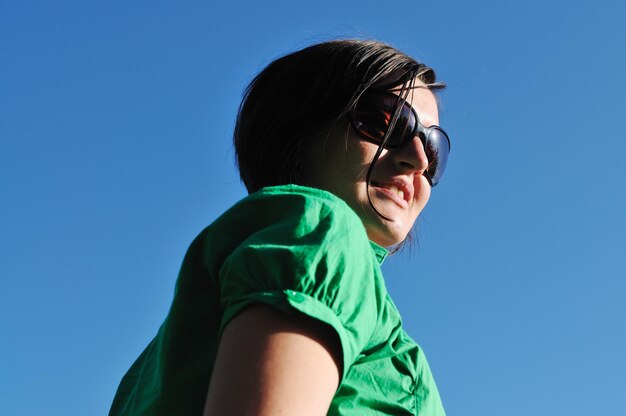 young beautiful brunette woman jump outdoor in fashion clothing and sunglasses