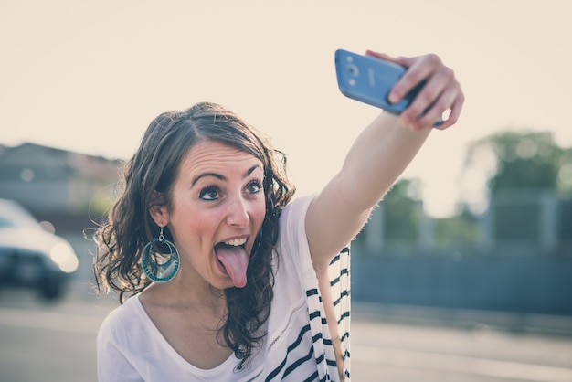 young beautiful brunette woman with smart phone