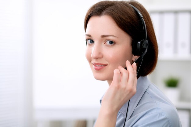 Young beautiful business woman in headset. Call center.