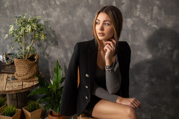 Young beautiful business woman sits on chair