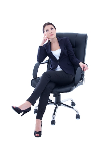 Young beautiful business woman sitting on the chair and dreaming isolated on white background