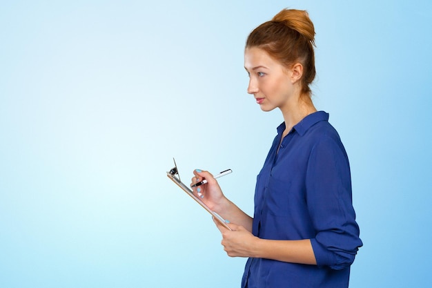 Young beautiful business woman with clipboard