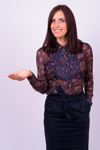  young beautiful businesswoman against white wall