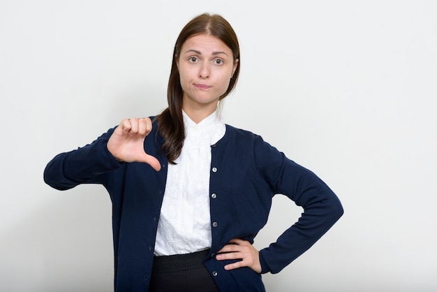 young beautiful businesswoman against white wall