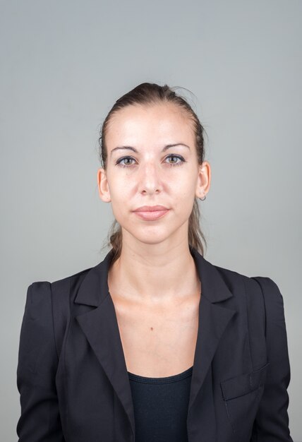 young beautiful businesswoman with brown hair against white space