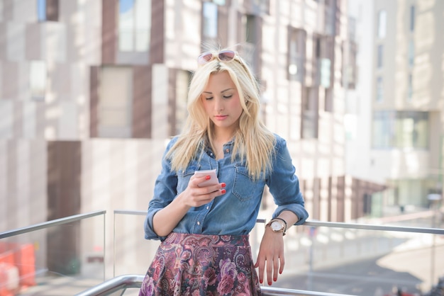 Young beautiful caucasian blonde girl in the city