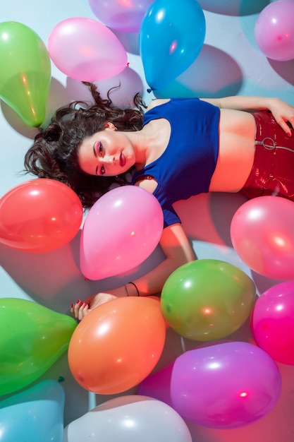 Young beautiful caucasian woman posing with balloon