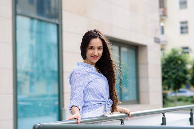 Young beautiful cheerful woman walking on old street at tropical town Pretty girl looking at you and smiling