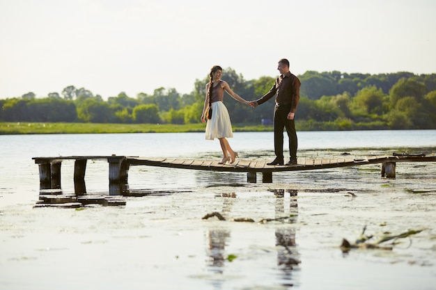 Young beautiful couple on a bridge