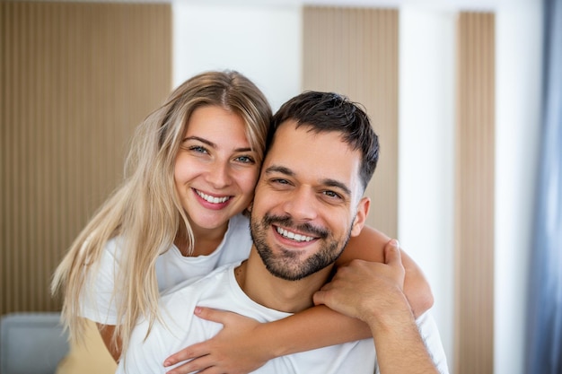 Young beautiful couple is lying in the bed at morning Portrait of a relaxed young couple lying in bed at home Beauty portrait