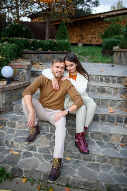 Young beautiful couple is sitting on the steps.