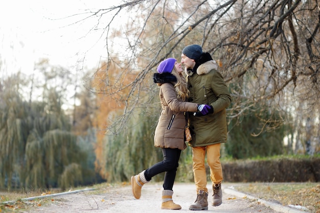 Young beautiful couple kissing at the park 