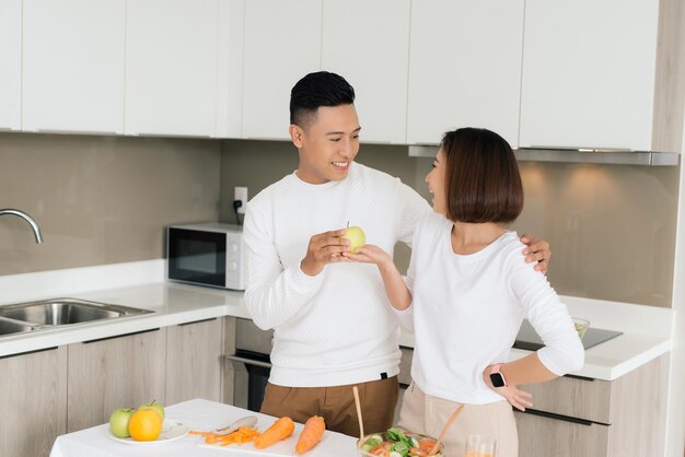 Young beautiful couple in kitchen Family of two preparing food