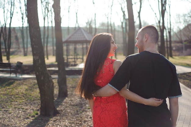 Young beautiful couple in love posing outdoor in city. Young woman smiling with her handsome man.