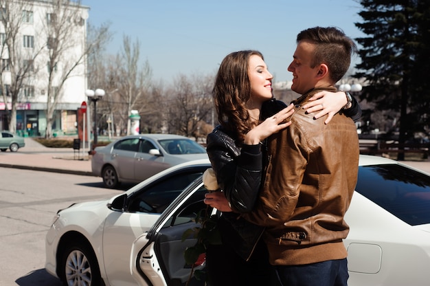 Young beautiful couple resting, walking in park, smiling, rejoicing. Outdoor background