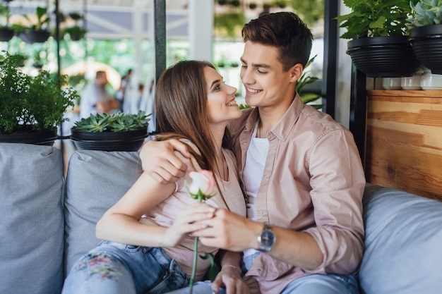 Young beautiful couple on a summer terrace