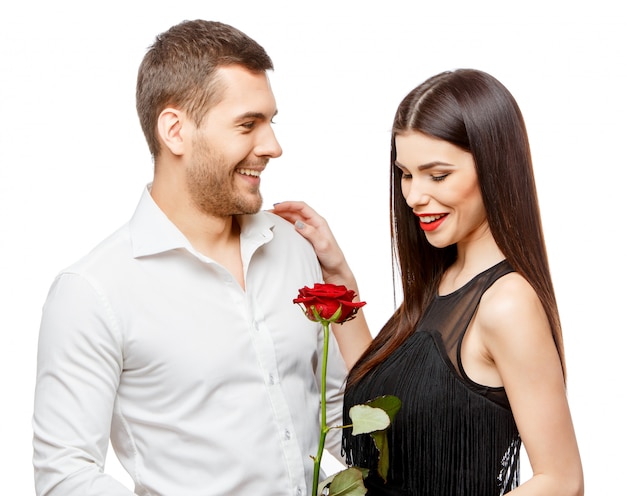 Young beautiful couple with flowers on white