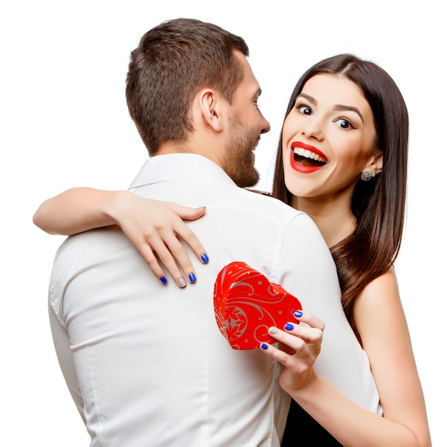 Young beautiful couple with present on white