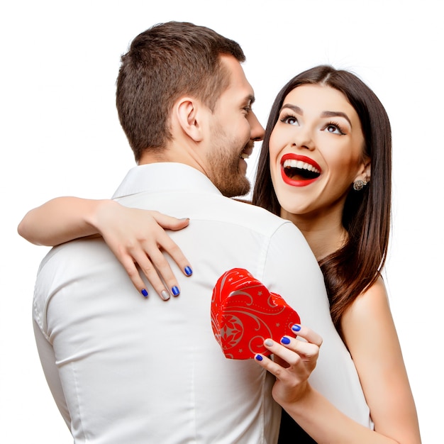 Young beautiful couple with present on white