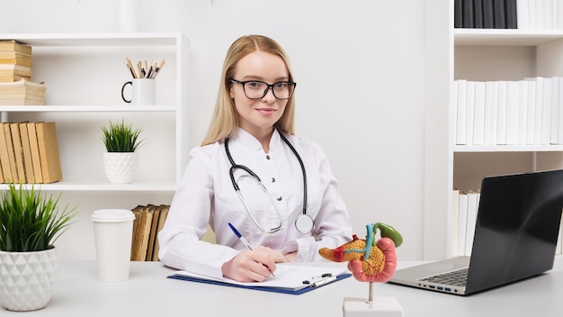 Young beautiful doctor woman working happy and smile in hospital sitting on table