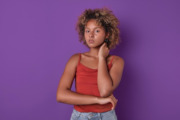 Young beautiful ethnic african american woman teenager stands in studio