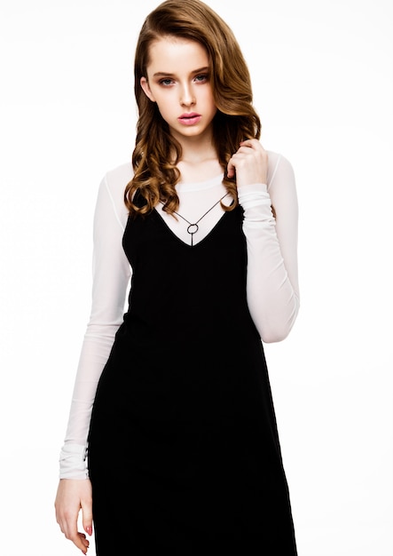 Young beautiful fashion model wearing black dress with white shirt on white 