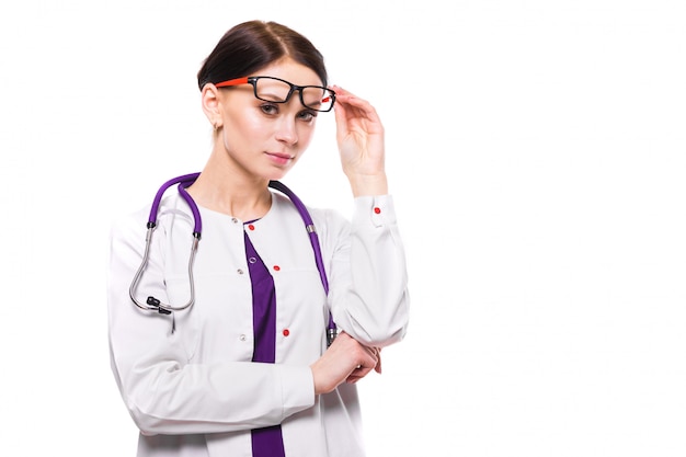 Young beautiful female doctor with raised glasses