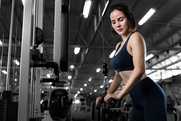 Young beautiful fit woman working out in the gym